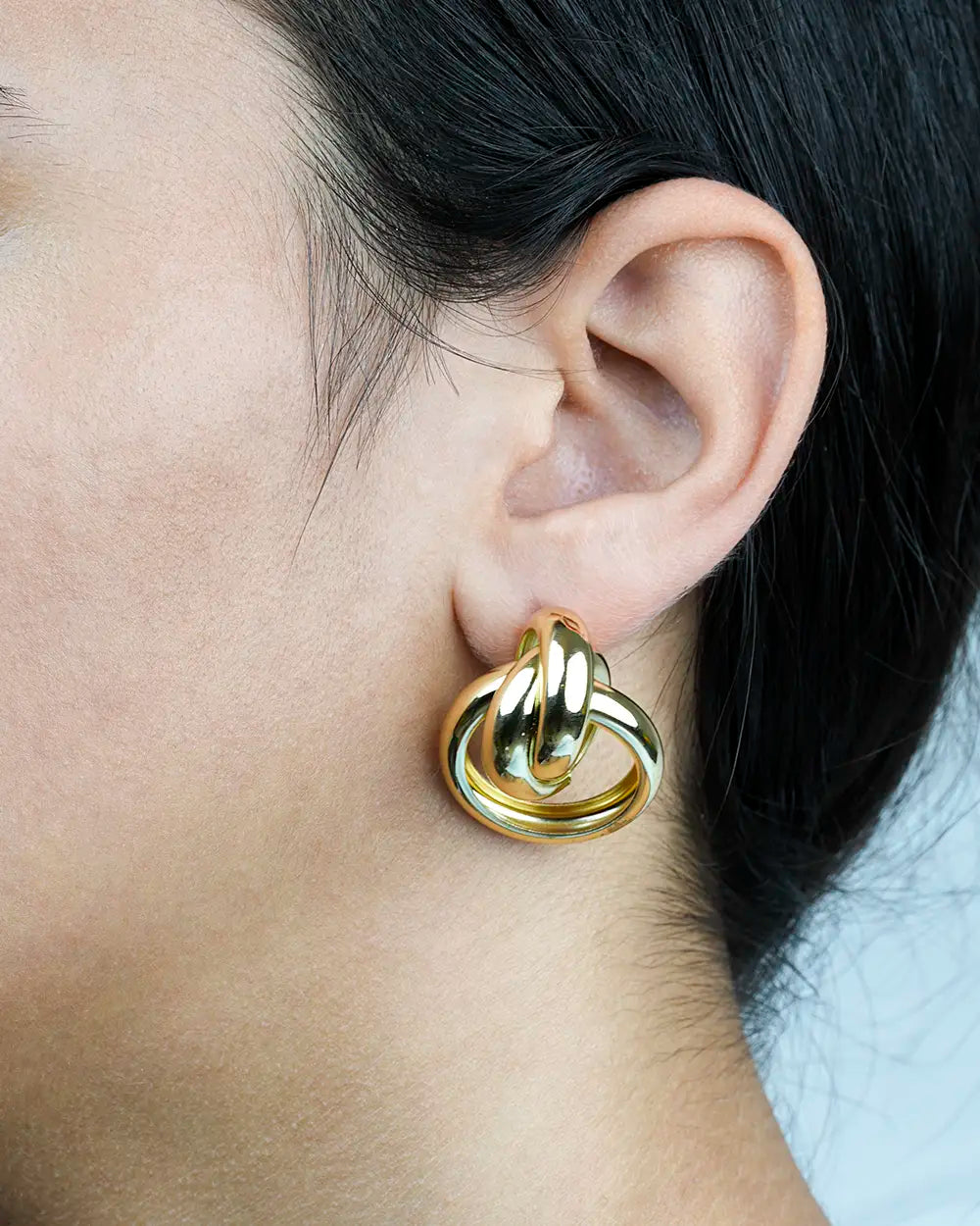 Model Wearing a Gold Knot Earrings Mid EG2400064
