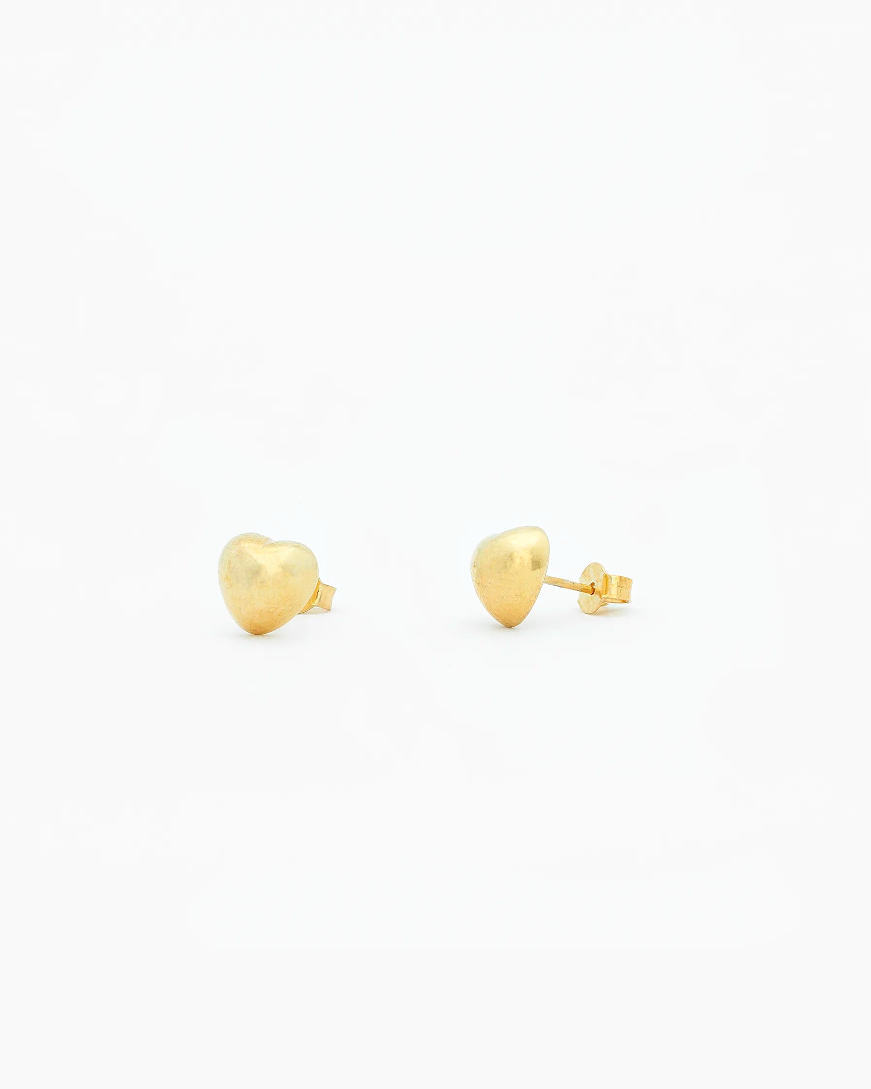 Gold stud earrings on a white background