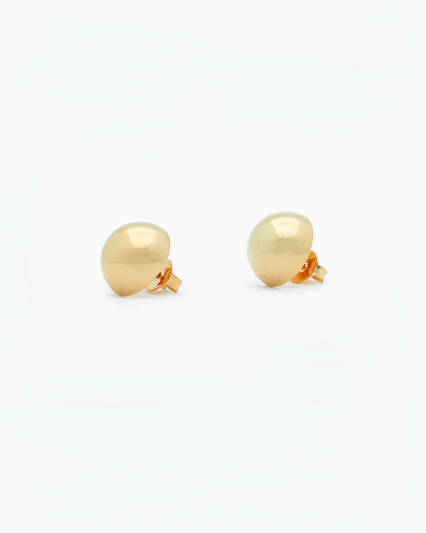 Gold ball earrings on a white background