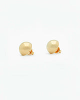 Gold ball earrings on a white background