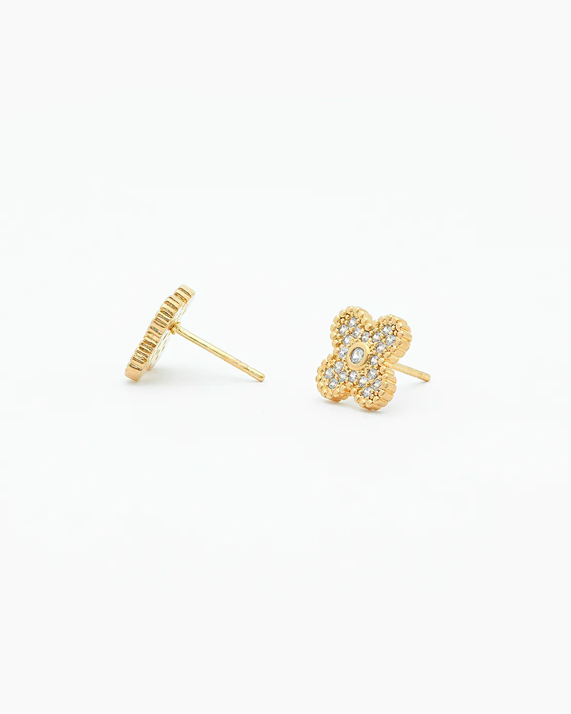Gold earrings with a clover design on a white background