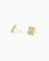 Gold earrings with a clover design on a white background