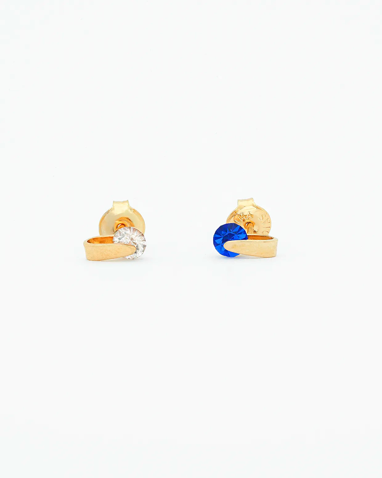 Gold earrings with blue gemstones on a white background