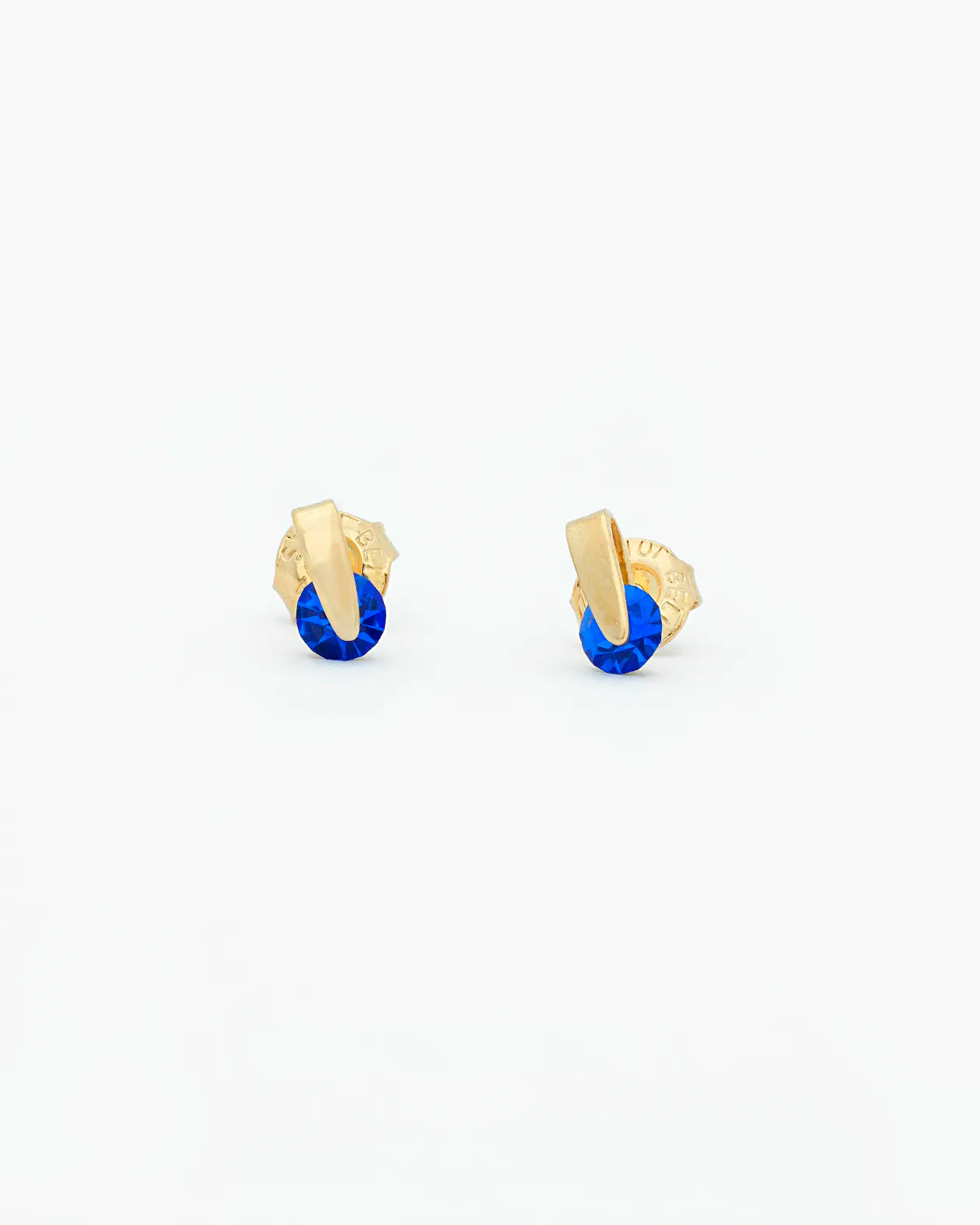 Gold earrings with blue stones on a white background
