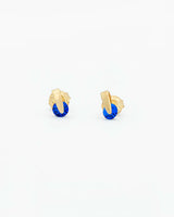 Gold earrings with blue stones on a white background