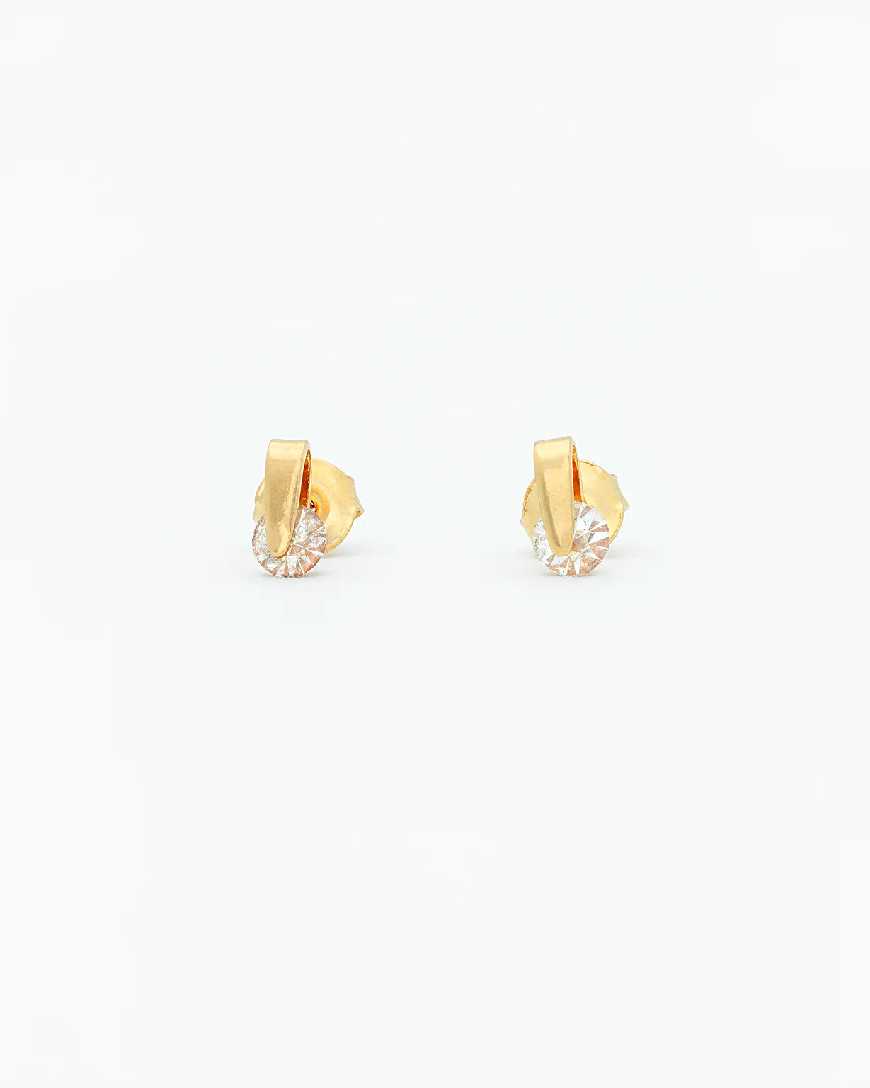 Gold earrings on a white background