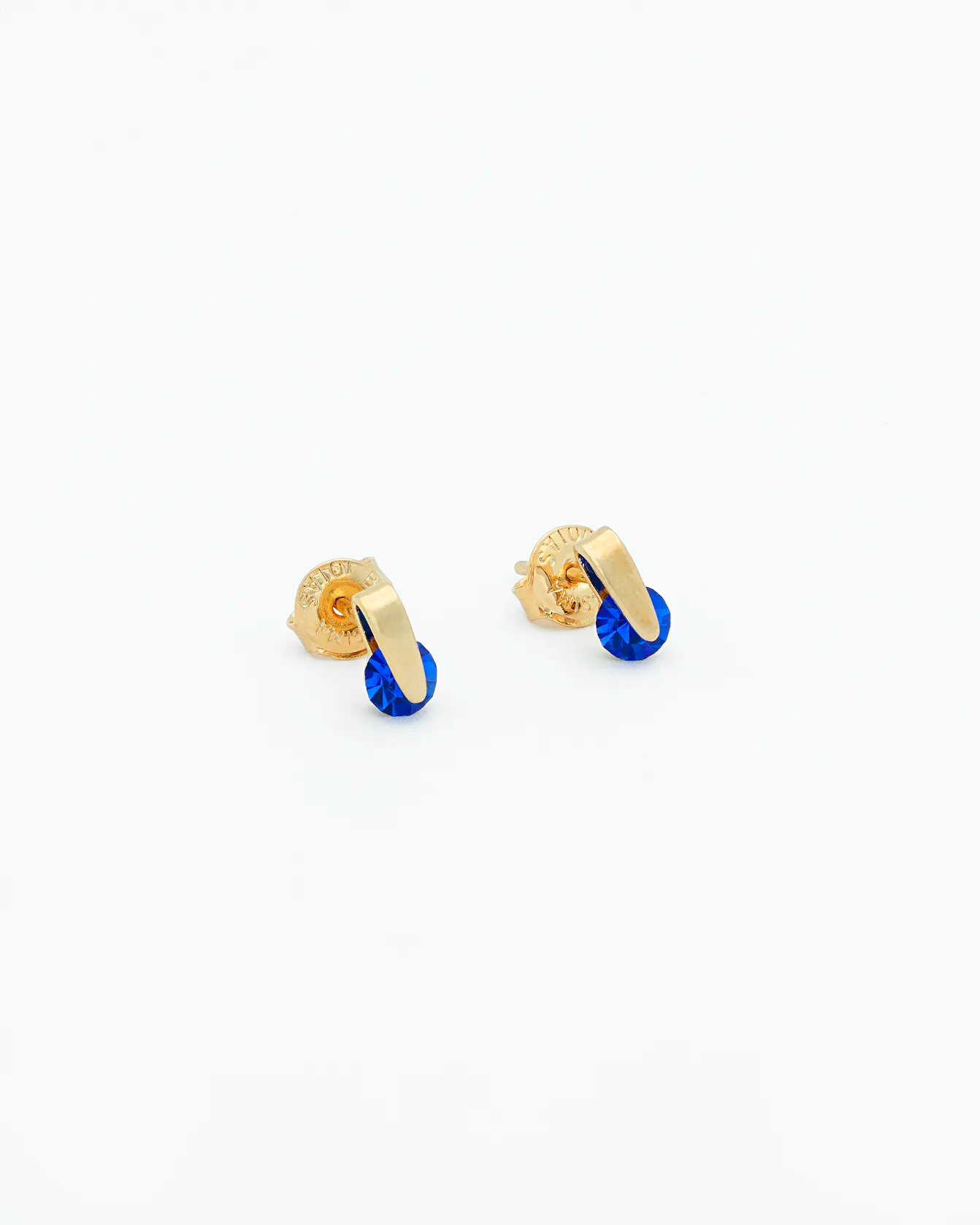 Gold and blue earrings on a white background