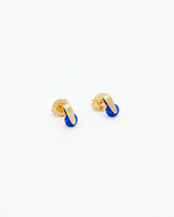 Gold and blue earrings on a white background
