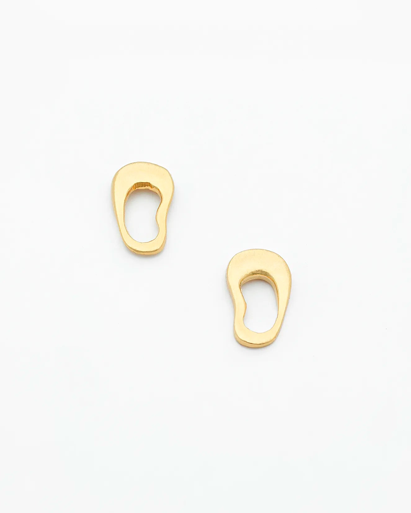 Two gold earrings on a white background