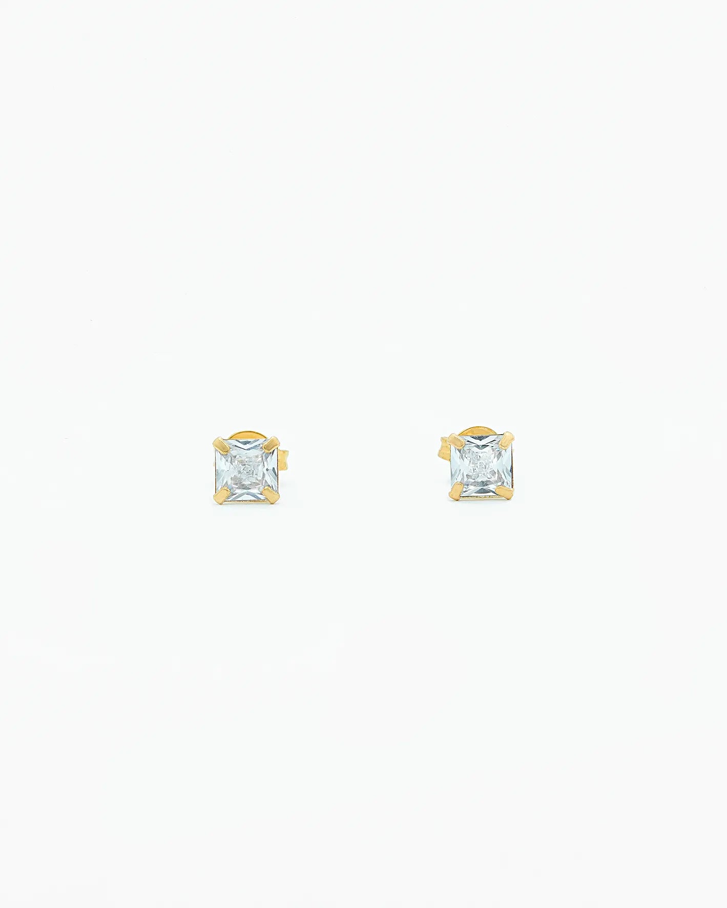 Two gold square-cut stud earrings on a white background
