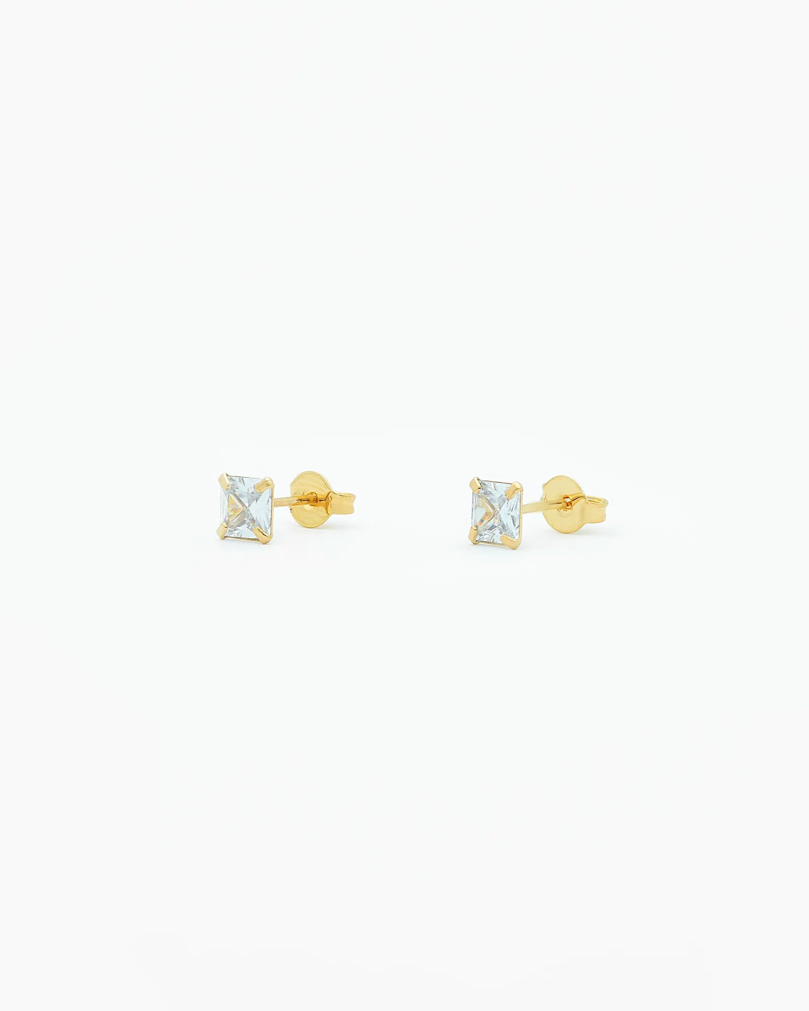 Gold stud earrings with square gemstones zirconia on a white background