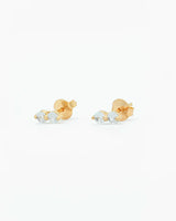 Gold earrings with clear gemstones on a white background