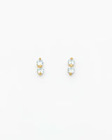 Pair of gold and clear crystal stud earrings on a white background