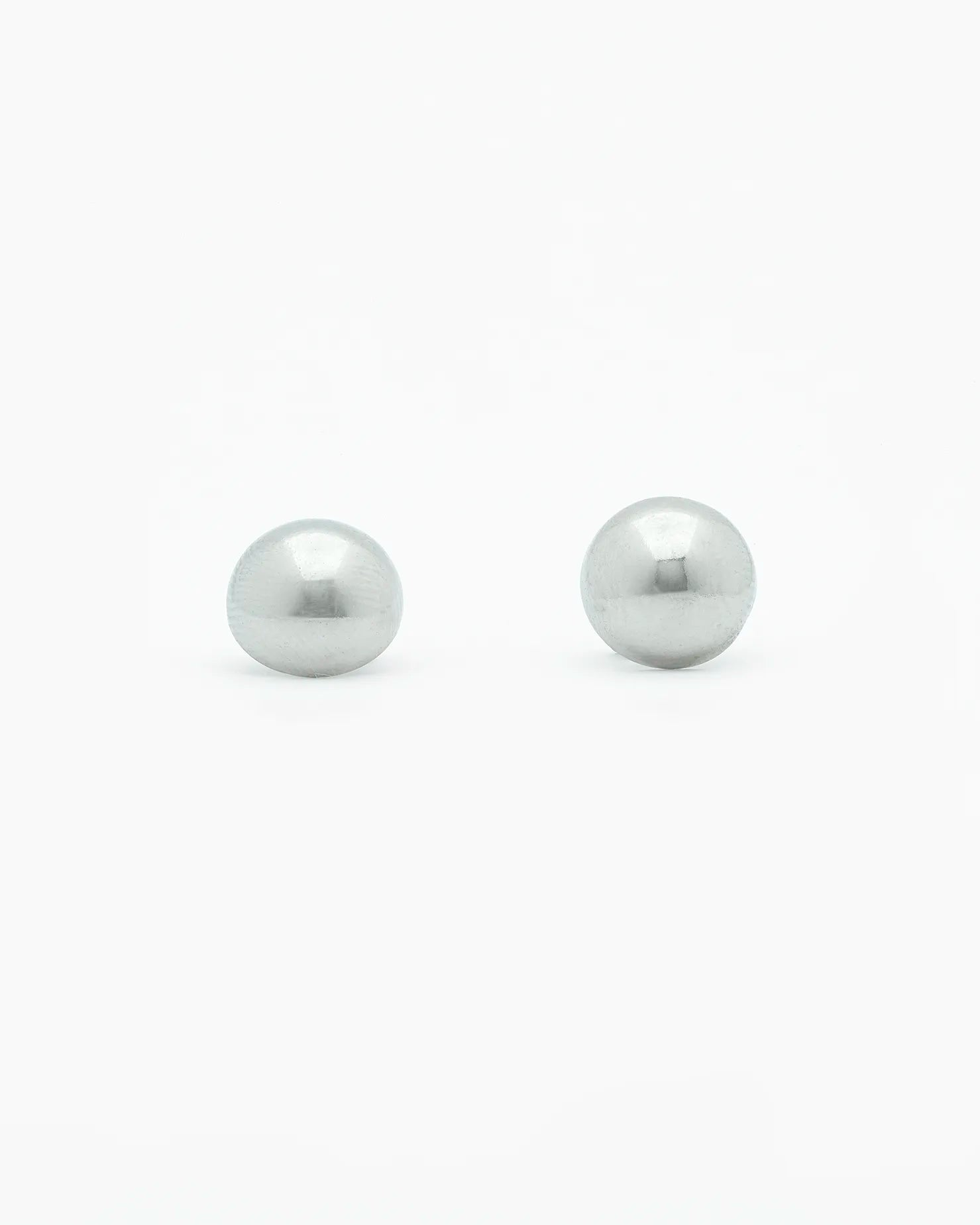 Two silver pearls on a white background