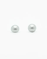Two silver pearls on a white background