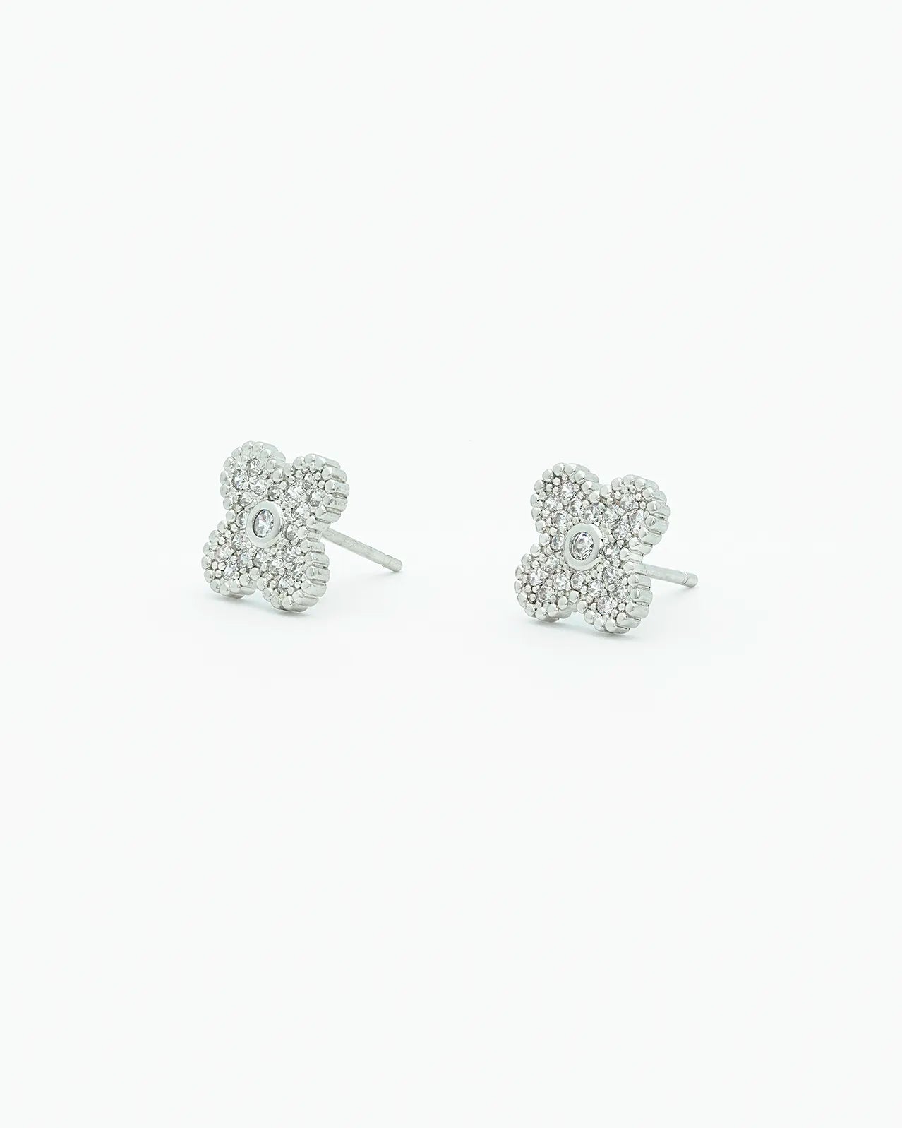 Pair of silver clover-shaped earrings on a white background