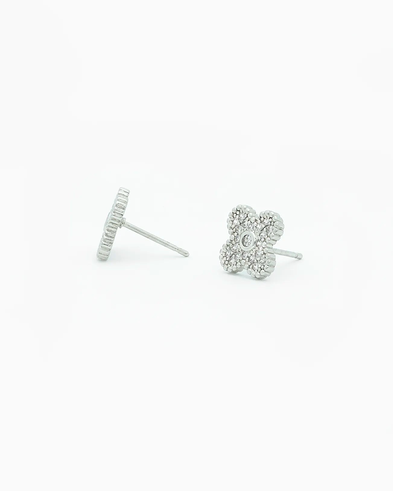 Silver flower-shaped earrings on a white background