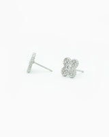 Silver flower-shaped earrings on a white background