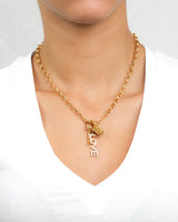 Model wearing 18k gold necklace with Love and Key pendant